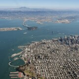 The Bay Bridge and the San Francisco Bay are seen from above in San Francisco, California.