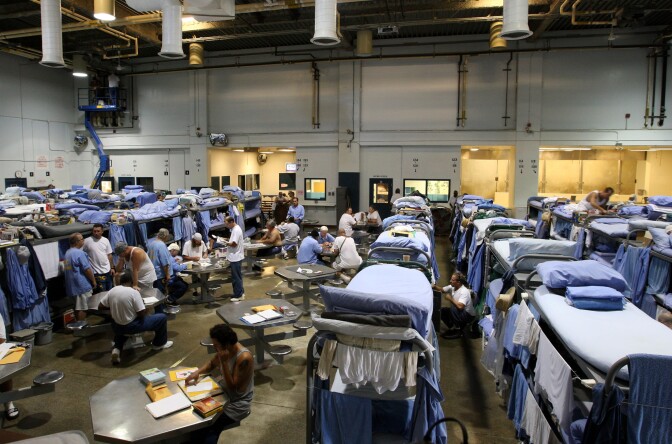 IONE, CA - AUGUST 28:  Inmates at the Mule Creek State Prison interact in a gymnasium that was modified to house prisoners August 28, 2007 in Ione, California. A panel of three federal judges is looking to put a cap on the California State Prison population after class action lawsuits were filed on behalf of inmates who complained of being forced to live in classrooms, gymnasiums and other non-traditional prison housing. California prisons house nearly 173,000 inmates with over 17,000 of them in non-traditional housing. The Mule Creek State Prison has had to modify several facilities to make room for an increasing number of inmates. (Photo by Justin Sullivan/Getty Images)