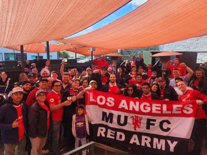 Photo of a crowd of soccer fans posing.