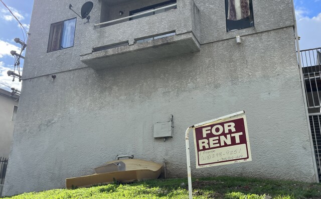 A "for rent" sign hangs outside an apartment building in the city of Los Angeles. 
