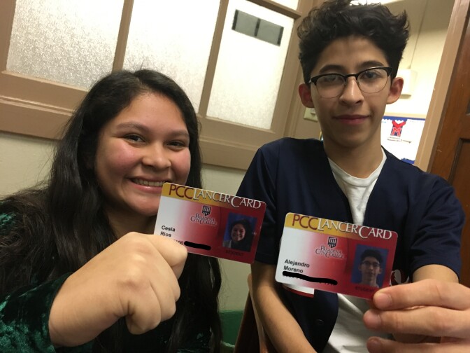 Pasadena high school students Cesia Rios (left) and Alex Moreno hold up college ID cards they received after taking dual enrollment college classes while in high school.