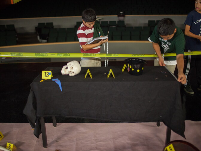 Francisco Gutierrez, 14, measures the interior of a mock crime scene at Cabrillo High School in Long Beach, Calif., on July 23.