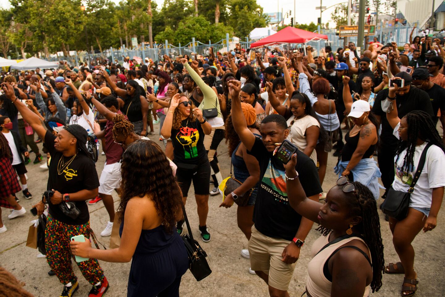 A large group of people dance during the Leimert Park Rising Juneteenth celebration on June 19, 2021 in the Leimert Park neighborhood of Los Angeles, California.
