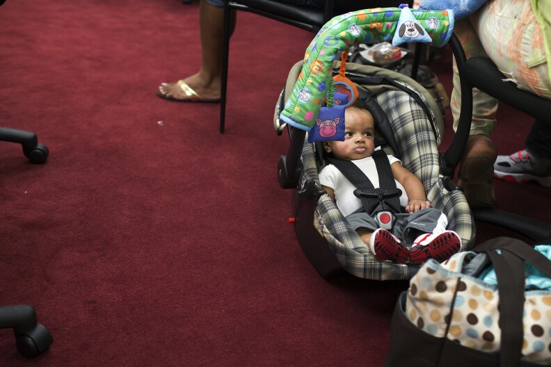 Four-month-old King Ace sits next to mother Shemera Williams during the social support and empowerment class on Monday Feb. 23.