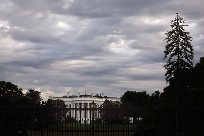 The white house under a dark grey sky. 