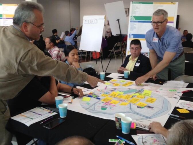 Boyle Heights restaurant owner Carlos Ortez, left, and outreach consultant Glen Dake discuss possible uses for Metro-owned land at Mariachi Plaza during a Metro workshop Saturday. Metro is seeking local input on what to build on Metro-owned land adjacent to the Mariachi Plaza Gold Line station. A plan to build retail and medial office space failed early last year after residents objected.