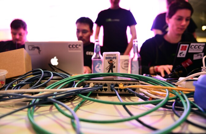 HAMBURG, GERMANY - DECEMBER 28:  Participants work at their their laptops at the annual Chaos Computer Club (CCC) computer hackers' congress, called 29C3, on December 28, 2012 in Hamburg, Germany. The 29th Chaos Communication Congress (29C3) attracts hundreds of participants worldwide annually to engage in workshops and lectures discussing the role of technology in society and its future. (Photo by Patrick Lux/Getty Images)