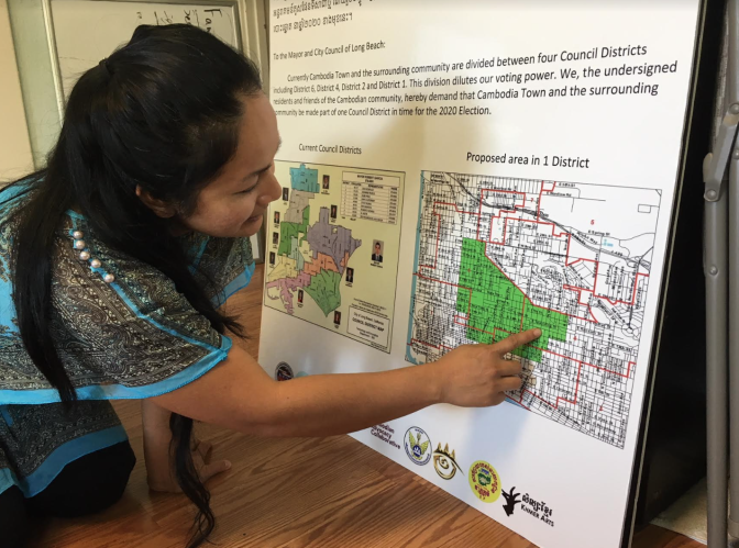 Lara Som, who directs the MAYE Center in Long Beach, points to a map of a proposed redrawn city council district that would encompass the city's Cambodia Town neighborhood and the surrounding area.