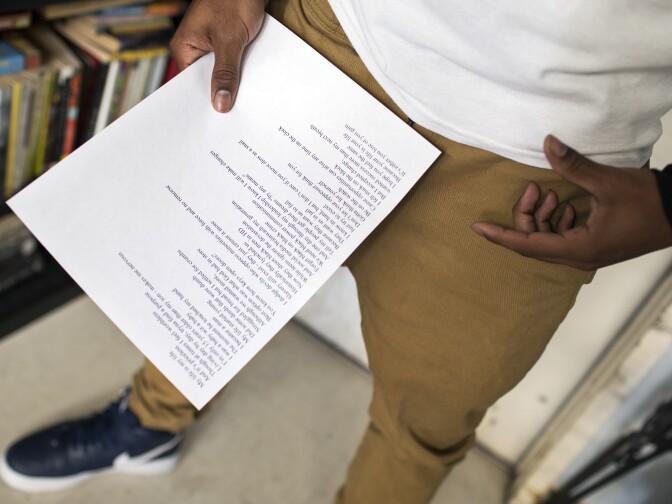 Senior Winston Thomas III reads his poem, "The Laughing Pain," during a rehearsal for the semifinals and finals of the Get Lit Classic Slam poetry competition at College Bridge Academy in Watts on Tuesday afternoon, April 19, 2016.