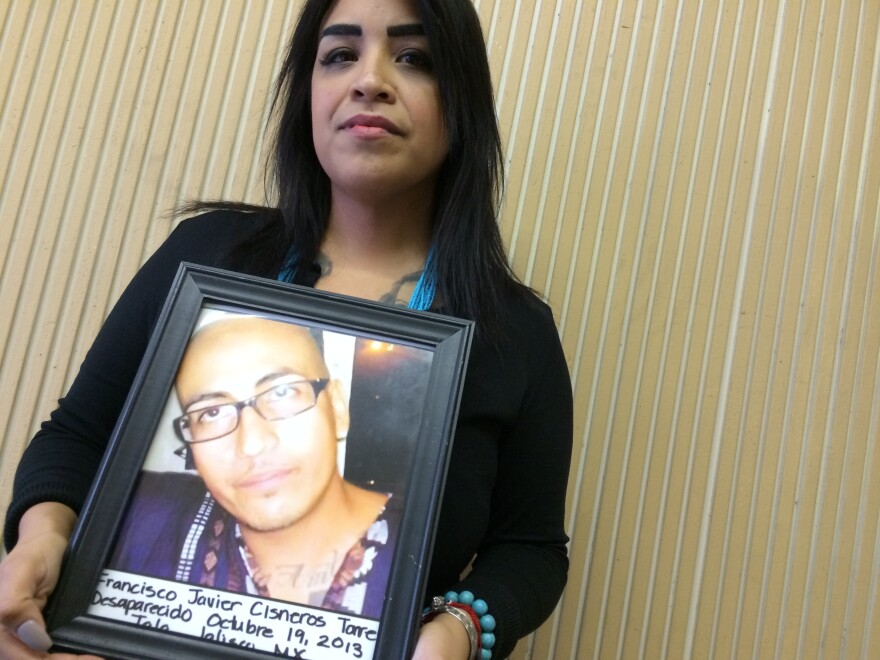 Nansi Cisneros holds a picture of her younger brother, Javier, who went missing in Jalisco in October 2013. Authorities in Mexico say an investigation is still ongoing.