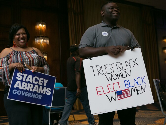 ATLANTA, GA - MAY 22: Supporters Denise Williams (left) and Darion Reed of Covington during the primary election night event for Georgia Democratic gubernatorial candidate Stacey Abrams on May 22, 2018 in Atlanta, Georgia. Abrams is running against former state representative Stacey Evans. (Photo by Jessica McGowan/Getty Images)