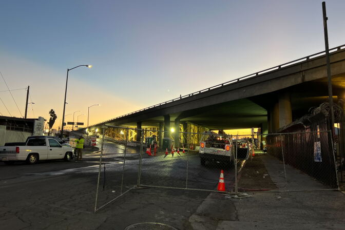 Wood scaffolding is visible under a raised roadway