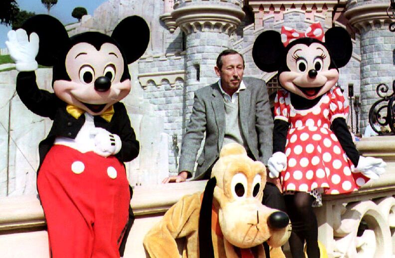 Roy Disney, son of Walt Disney, poses with Mickey,