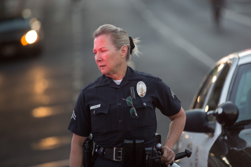 A police officer blocks off 1st St. in downtown Los Angeles to allow protesters to march on July 16th, 2013.