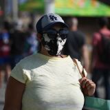 A woman wearing a facemask walks on the boardwalk as many come to the beach to escape the heat wave in Venice Beach, California on September 4, 2020. - California is bracing for all-time record-breaking temperatures and dangerous fire weather conditions this Labor Day weekend, with the National Weather Service urging people to limit outdoor activity and to stay hydrated.
"Saturday and Sunday will be about 20 to 30 degrees above normal across the entire area," Franker Fisher, a meteorologist for the southern part of the state, told AFP. (Photo by Robyn Beck / AFP) (Photo by ROBYN BECK/AFP via Getty Images)