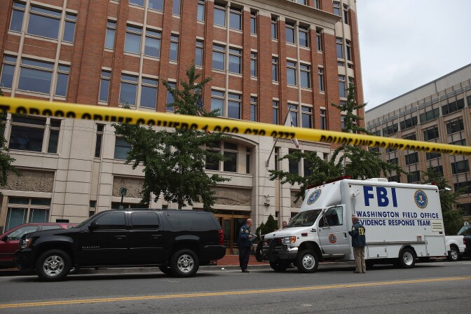 WASHINGTON, DC - AUGUST 15:  Local and federal investigators work to gather evidence after a security guard was shot in the arm at the headquarters of the Family Research Council August 15, 2012 in Washington, DC. The shooter is in FBI custody and has not yet been charged, authorities said. The Family Research Council is a conservative organization that is against abortion and euthanasia and considers homosexuality to be a sin.  (Photo by Chip Somodevilla/Getty Images)