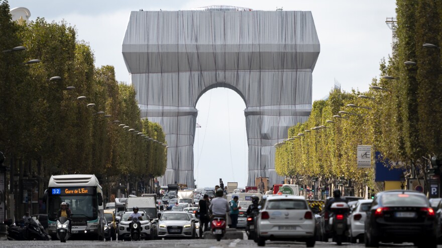 The Arc de Triomphe in Paris is seen wrapped in fabric, in a posthumous art project that is an homage to the late artists Christo and Jeanne-Claude .