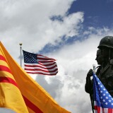 WESTMINSTER, CA - APRIL 28:  A statue depicting an American and South Vietnamese soldier is surrounded by American and old-style Vietnamese flags at the Vietnam War Memorial on April 28, 2005 near the Little Saigon section in Westminster, California. Vietnamese-Americans are preparing to commemorate the 30th anniversary of the fall of the US-backed Saigon government on April 30. Little Saigon, the nation's largest Vietnamese business district, was populated by large numbers of Vietnamese refugees, many of whom were "boat people" refugees, in the late 1970's and 1980's.  (Photo by David McNew/Getty Images)