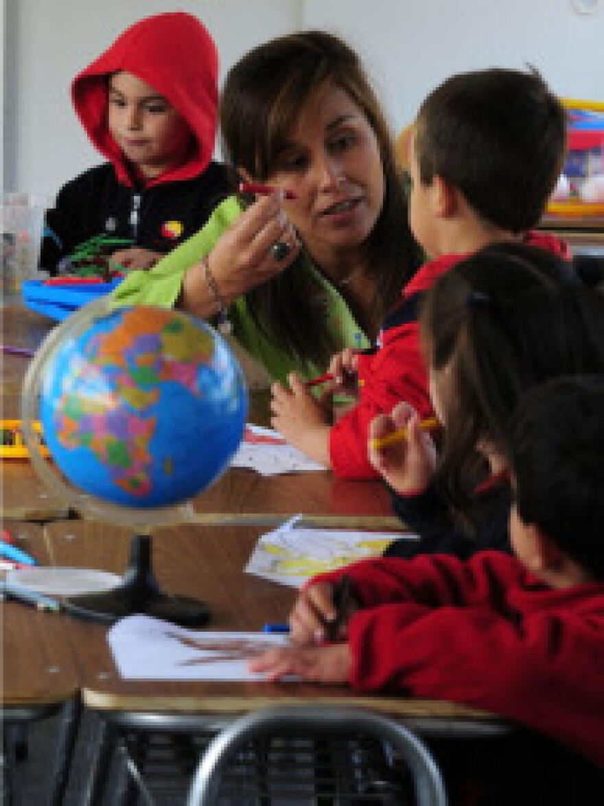 A teacher talks to a little boy on April 26, 2010 during her instruction at school