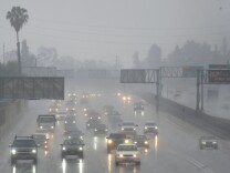 Commuters drive under heavy rainfall in Los Angeles, California on March 21, 2018
A slow-moving storm, billed as an "atmospheric river" began unleashing rain across southern California. Mandatory evacuations have been ordered by officials in Santa Barbara, Ventura and Los Angeles counties. / AFP PHOTO / Frederic J. Brown        (Photo credit should read FREDERIC J. BROWN/AFP/Getty Images)