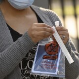 A person opens a Covid-19 oral swab test at a pop-up community testing site in the Panorama City neighborhood of Los Angeles, California, December 9, 2020. (Photo by Patrick T. Fallon / AFP) (Photo by PATRICK T. FALLON/AFP via Getty Images)