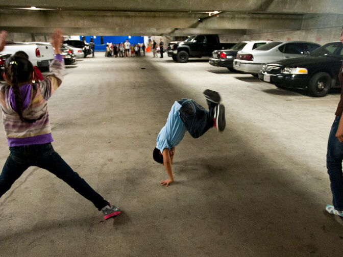 Kids do cartwheels after running during an exercise drill. The Newton Street Police Activities League also offers martial arts, boxing, yoga, and gardening, among many other activities for kids in the community.