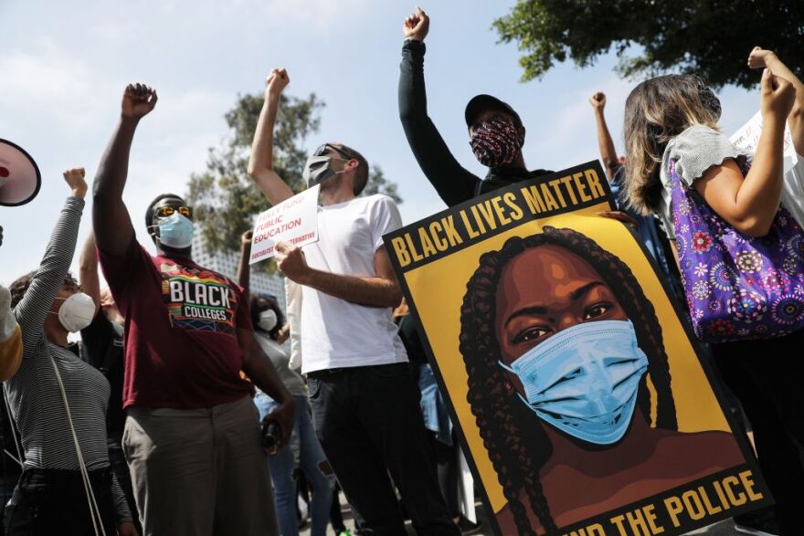 LOS ANGELES, CALIFORNIA - JUNE 23: Black Lives Matter-Los Angeles supporters protest outside the Unified School District headquarters calling on the board of education to defund school police on June 23, 2020 in Los Angeles, California. The demonstrators want the funds currently spent on campus police to be reallocated to other student-serving priorities.  (Photo by Mario Tama/Getty Images)