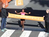 Amane Gobena of Ethiopia reacts as she crosses the finish line to win  the women's elite class of the Los Angeles Marathon on March 9, 2014 in Santa Monica, California.