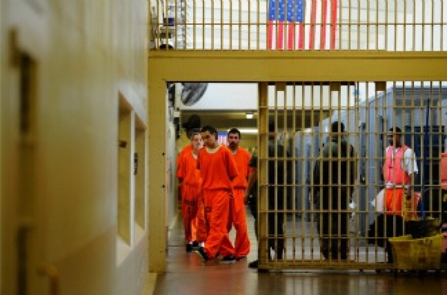 Inmates at Chino State Prison walk the hallway on December 10, 2010 in Chino, California.