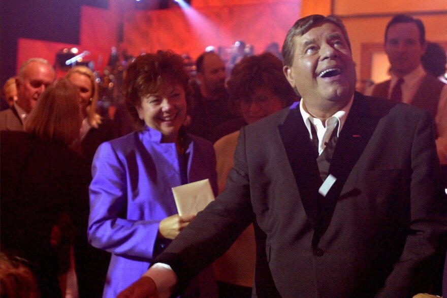 Lewis and his wife, Sam, look toward the audience after closing his Muscular Dystrophy Telethon in 2000. He helped raise more than $50 million in under 22 hours.