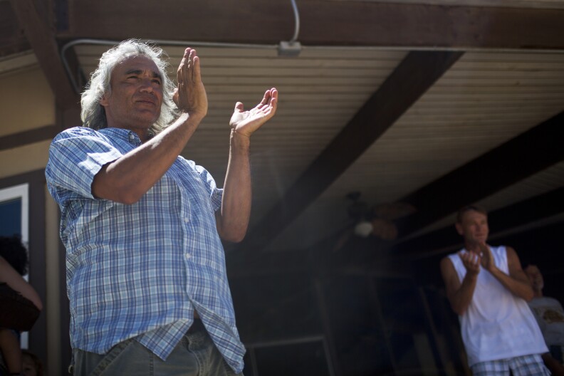 Ambrose Smith of Salton City applauds as Randy Brown arrives for lunch and a swim at Vista Del Mar Clubhouse during his six-day walk around the Salton Sea on Friday, June 12, 2015. Smith, who has lived near the Salton Sea for nine years, has been following Brown's journey all week.