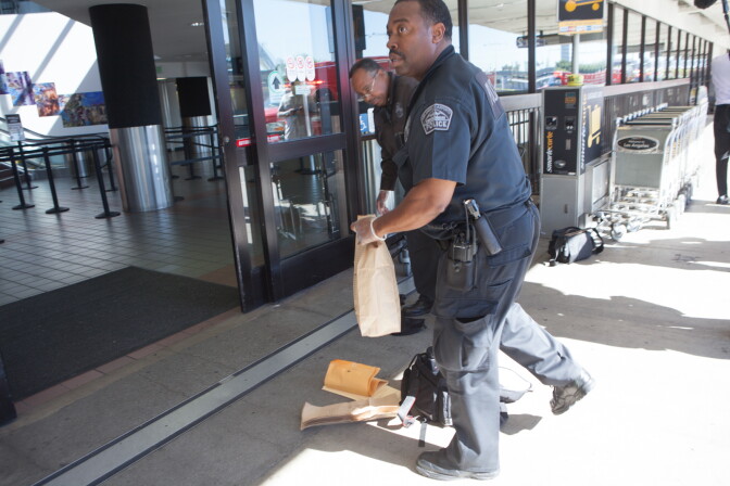 LAX police officers gather evidence outside an LAX terminal following a shooting on November 1st, 2013.