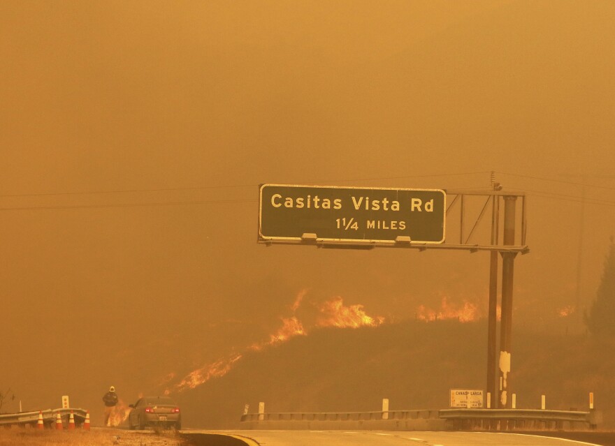 Flames and smoke shroud State Route 33 as a wildfire burns in Ventura on Tuesday, Dec. 5, 2017.