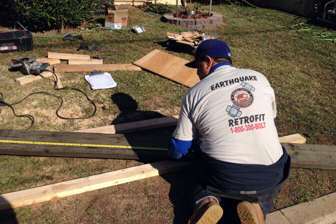 Bulmaro Roderte, a crew leader with the company Seismic Safety, measures wood used to retrofit a home in Eagle Rock. Seismic Safety is one of the companies approved by the California Earthquake Authority to participate in a pilot program to encourage homeowners to retrofit.