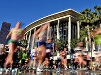 Participants run past the Dorothy Chandler Pavilion and the Los Angeles Music Center during the 2016 L.A. Marathon on February 14, 2016.