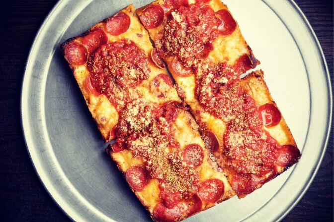 4 slices of pizza sit on top of a plate.