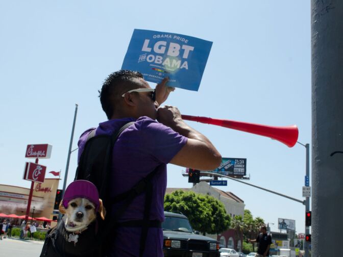 Arthur Navarro yells "Don't promote hate. Don't eat Chick-fil-a! Stand with our President. Equality for all!" while encouraging motorists and passers by to join in by honking their horn and joining his chant.
