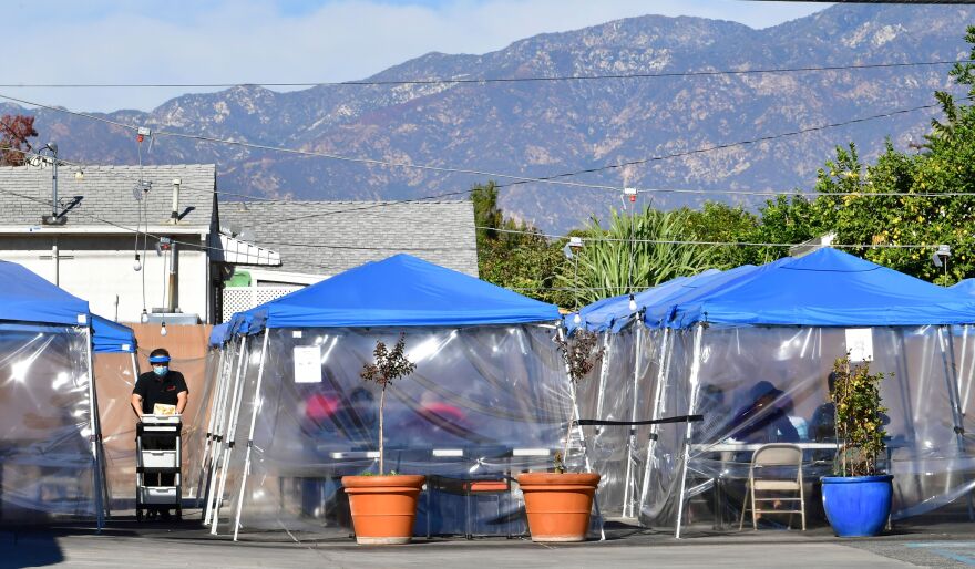 Tents for outdoor dining are seen in a restaurant's parking lot on November 17, 2020 in Alhambra, California, amid the coronavirus pandemic. - US states and cities are imposing a raft of new restrictions to try to curb soaring Covid-19 infection rates. (Photo by Frederic J. BROWN / AFP) (Photo by FREDERIC J. BROWN/AFP via Getty Images)