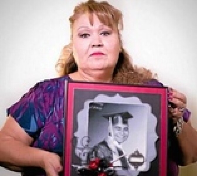 Margaret Gutierrez-Ramirez, of West Covina, holds a picture of her son, Antonio "Tony" Ramirez, during an interview at the San Gabriel Valley Tribune on Tuesday, Nov. 18, 2014. (Photo by Watchara Phomicinda/ San Gabriel Valley Tribune)