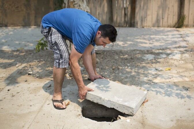 Joel Beltran says this area next to his mobile home becomes filled with sewage when the underground septic tank overflows. Beltran lives in Shady Lane Mobile Home Park in Thermal with his wife and four kids.