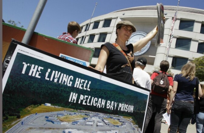 A demonstrator holds up a sign during a rally in front of the State Building in San Francisco on July 1, 2011 to support prisoners at Pelican Bay State Prison. Inmates in an isolation unit at Pelican Bay State Prison are on a hunger strike to protest conditions that they describe as inhumane. Advocates say several dozen inmates in the Security Housing Unit declined to eat their morning meal on Friday. The unit holds about a third of the 3,100 inmates at the Northern California prison. 