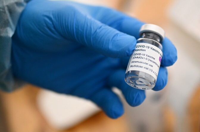 A doctor shows an empty vial of AstraZeneca vaccine against the coronavirus (Covid-19) are seen at a drive-in for vaccinations in Schwelm, western Germany, on April 7, 2021, amid the ongoing pandemic. - Because the appointments at the vaccination centre in the Ennepe-Ruhr district are booked up for weeks, the administration reacted and set up the temporary vaccination drive-in (approx. 500 metres long, two vaccination tents, 40 employees) on the car park of a sports hall on the Easter weekend. (Photo by Ina FASSBENDER / AFP) (Photo by INA FASSBENDER/AFP via Getty Images)