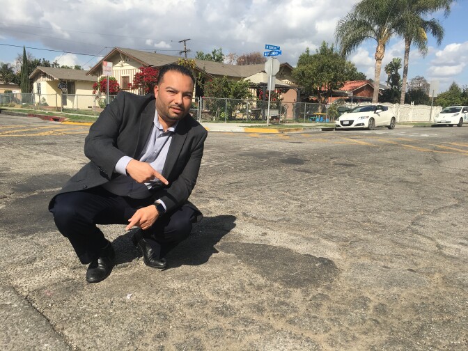 Lynwood Mayor Jose Luis Salache on deteriorated Duncan Avenue whose repair is accelerated with money from SB1, California's new gas tax.