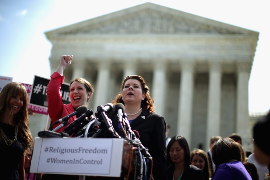 Lori Windham (C), senior counsel for The Becket Fund for Religious Liberty,addresses the news media in front of the Supreme Court after the decision in Burwell v. Hobby Lobby Stores June 30, 2014 in Washington, DC. The high court ruled 5-4 that requiring family-owned corporations to pay for insurance coverage for contraception under the Affordable Care Act violated a federal law protecting religious freedom.