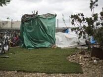 Pieces of artificial turf and rugs surround a tent in the Arroyo Seco riverbed along the 110 Freeway on Tuesday morning, May 5, 2015.