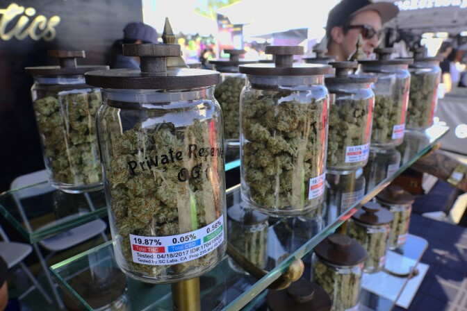 Jars of marijuana are on display for sale at the Cali Gold Genetics booth during the High Times Cannabis Cup in San Bernardino on April 23, 2017. 