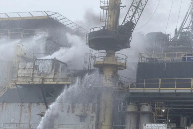 Smoke rises from an oil platform.