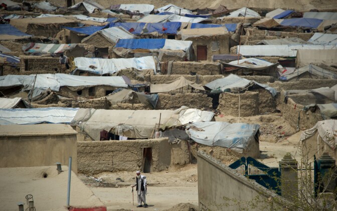 An Afghan man walks down a street next to the Nasaji Bagrami refugee camp in Kabul on April 18, 2012. Poverty and an ongoing insurgency by the ousted Taliban still pose a threat to the stability of the country. AFP PHOTO/ JOHANNES EISELE (Photo credit should read JOHANNES EISELE/AFP/Getty Images)
