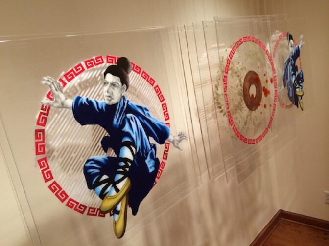 "Tàu Bay," by Trinh Mai, acknowledges the phrase's two meanings: one is a Vietnamese description for an extra large serving of pho, and the other is a homonym for "flying Chinese." Mai interprets both with two flying people -- renderings of her and her friend -- flanking a bowl of pho.