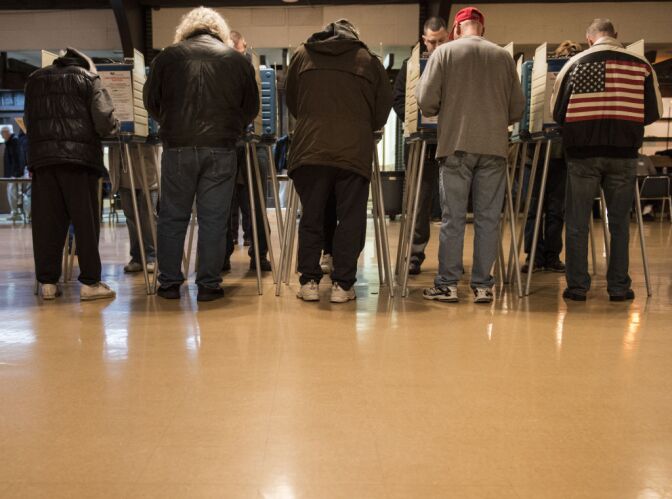 People vote at the United Auto Workers Local 1250 Hall during election day November 6, 2012 in Cleveland, Ohio. Citizens around the United States head to the polls to vote on the country's next president including in Ohio, a state with 18 electoral votes, were the race between US President Barack Obama and Mitt Romney is very close. 